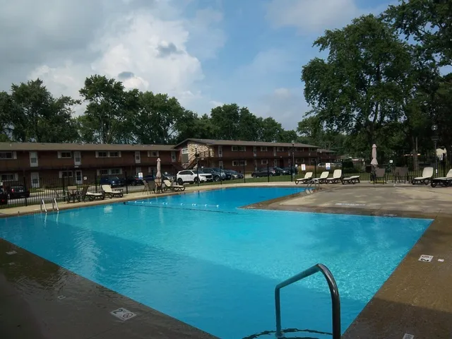 a view of a swimming pool with outdoor seating