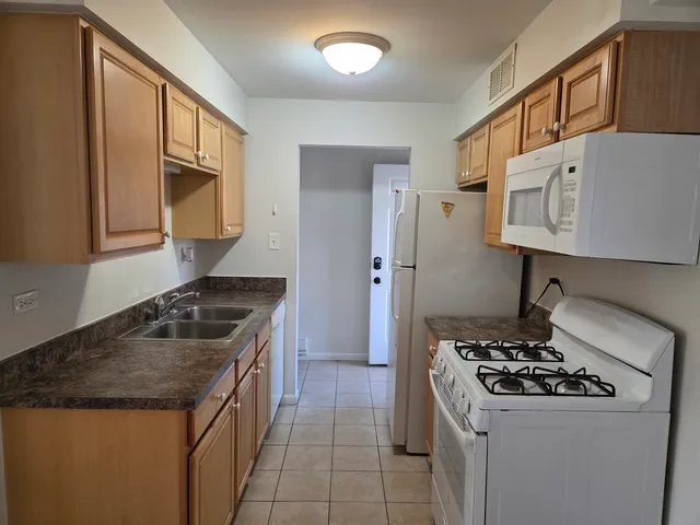 a kitchen with stainless steel appliances granite countertop a stove and a sink
