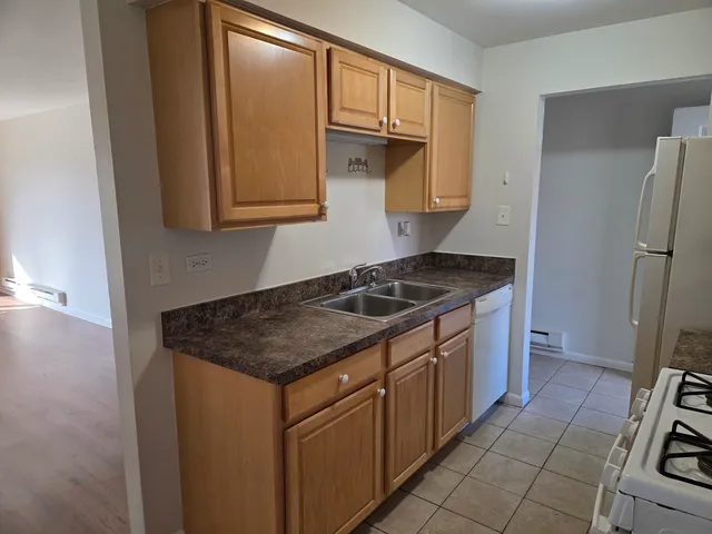 a kitchen with a sink stove and cabinets