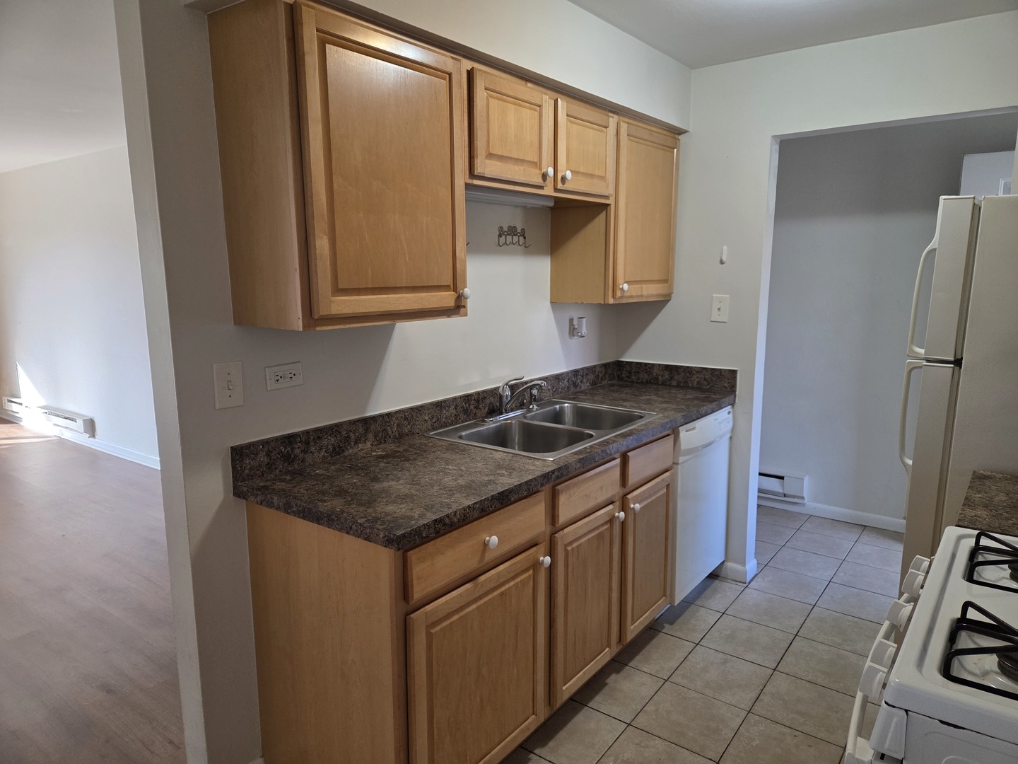 1500 Busse Road, Unit 2D Mount Prospect, IL 60056 - Photo 4 of 18 a kitchen with a sink stove and cabinets