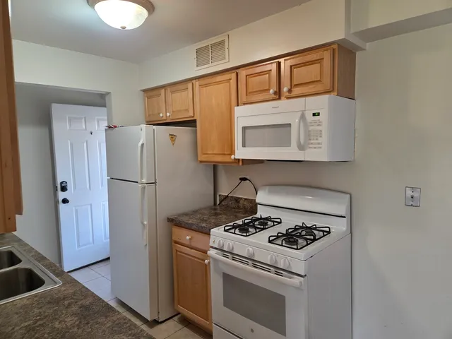 a kitchen with a stove and a refrigerator