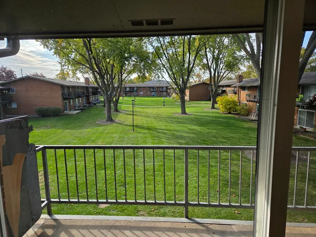 a view of a house with a big yard and potted plants