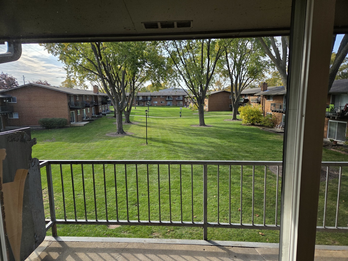 1500 Busse Road, Unit 2D Mount Prospect, IL 60056 - Photo 8 of 18 a view of a house with a big yard and potted plants