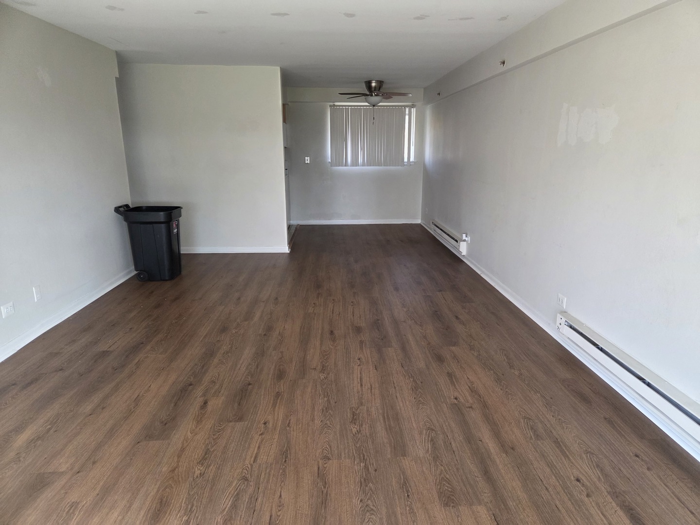 1500 Busse Road, Unit 2D Mount Prospect, IL 60056 - Photo 10 of 18 wooden floor in an empty room with a window