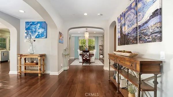 a dining room with furniture a window and wooden floor