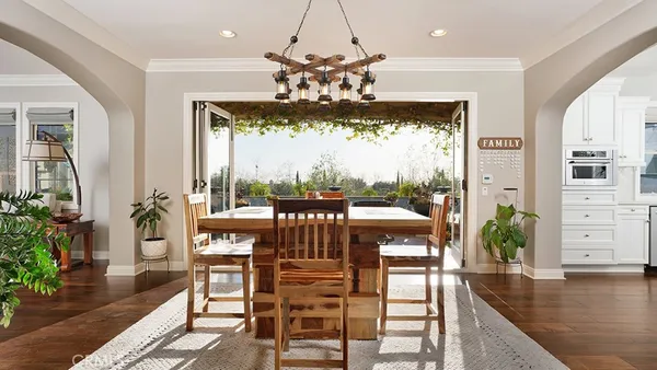 a view of a dining room with furniture and chandelier