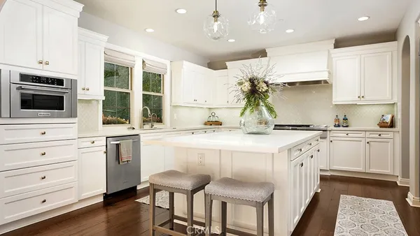 a view of a dining room with furniture wooden floor and chandelier