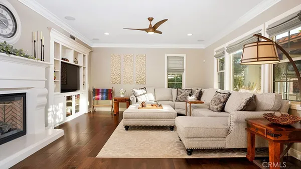 a living room with flat screen tv and a dresser