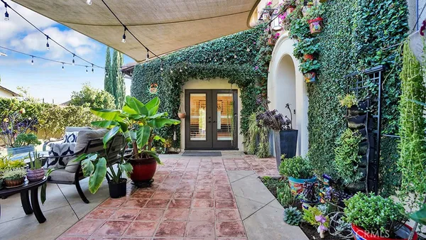 a view of a swimming pool with lawn chairs under an umbrella