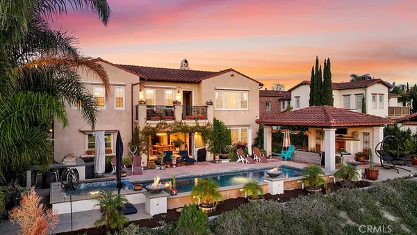 a front view of a house with swimming pool garden and patio