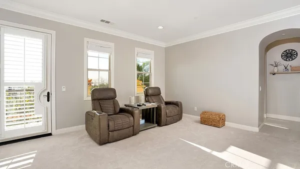 a spacious bedroom with a bed and a chandelier