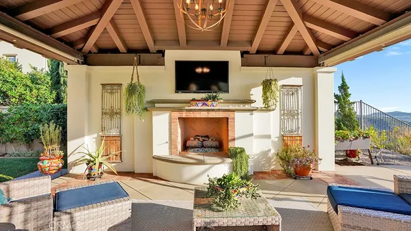 a view of a patio with table and chairs potted plants with wooden floor