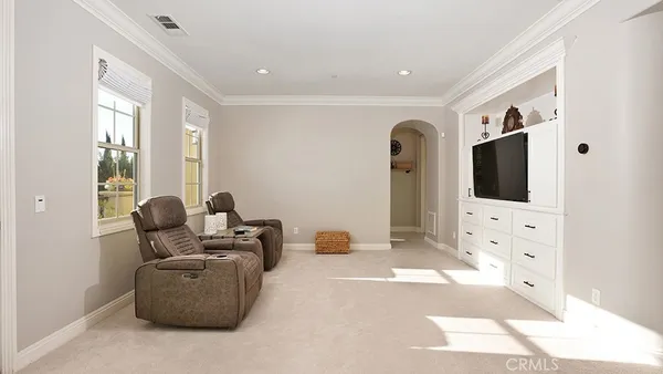 a view of a swimming pool with a patio and plants