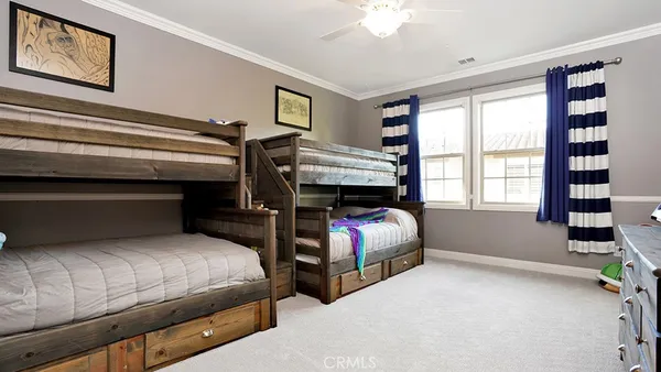 a front view of a house with a garden and plants