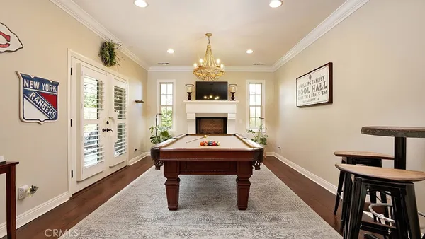a view of a workspace with furniture and wooden floor