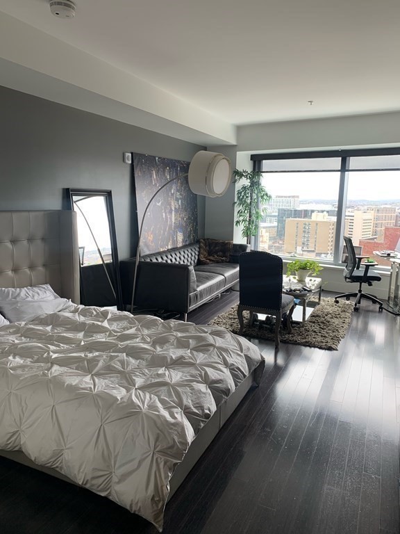 110 Stuart Street, Unit 24I Boston, MA 02116 - Photo 4 of 24 a bedroom with furniture and a large window