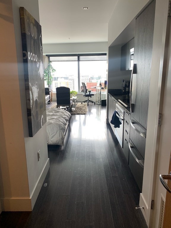 110 Stuart Street, Unit 24I Boston, MA 02116 - Photo 6 of 24 a living room with furniture and a large window
