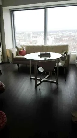 a living room with furniture and floor to ceiling window