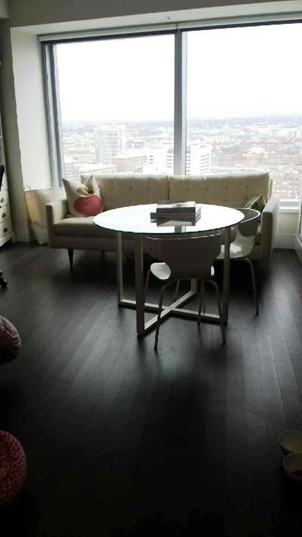 110 Stuart Street, Unit 24I Boston, MA 02116 - Photo 9 of 24 a living room with furniture and floor to ceiling window