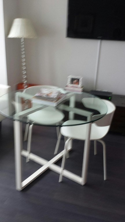 110 Stuart Street, Unit 24I Boston, MA 02116 - Photo 10 of 24 a kitchen with a table chairs and a stove