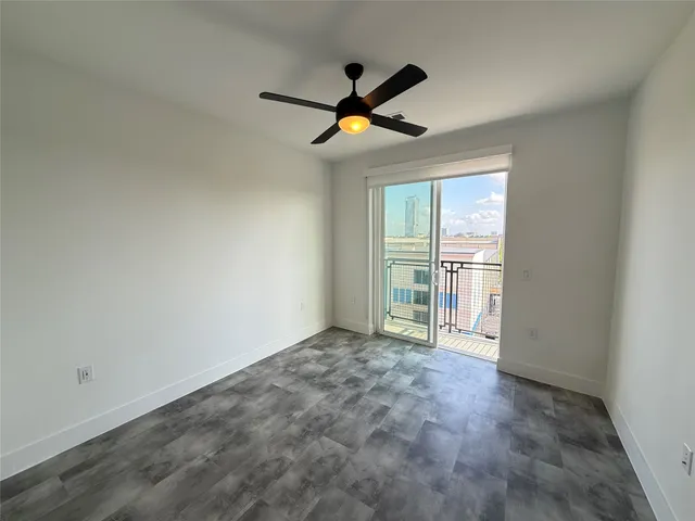 an empty room with windows and cabinet