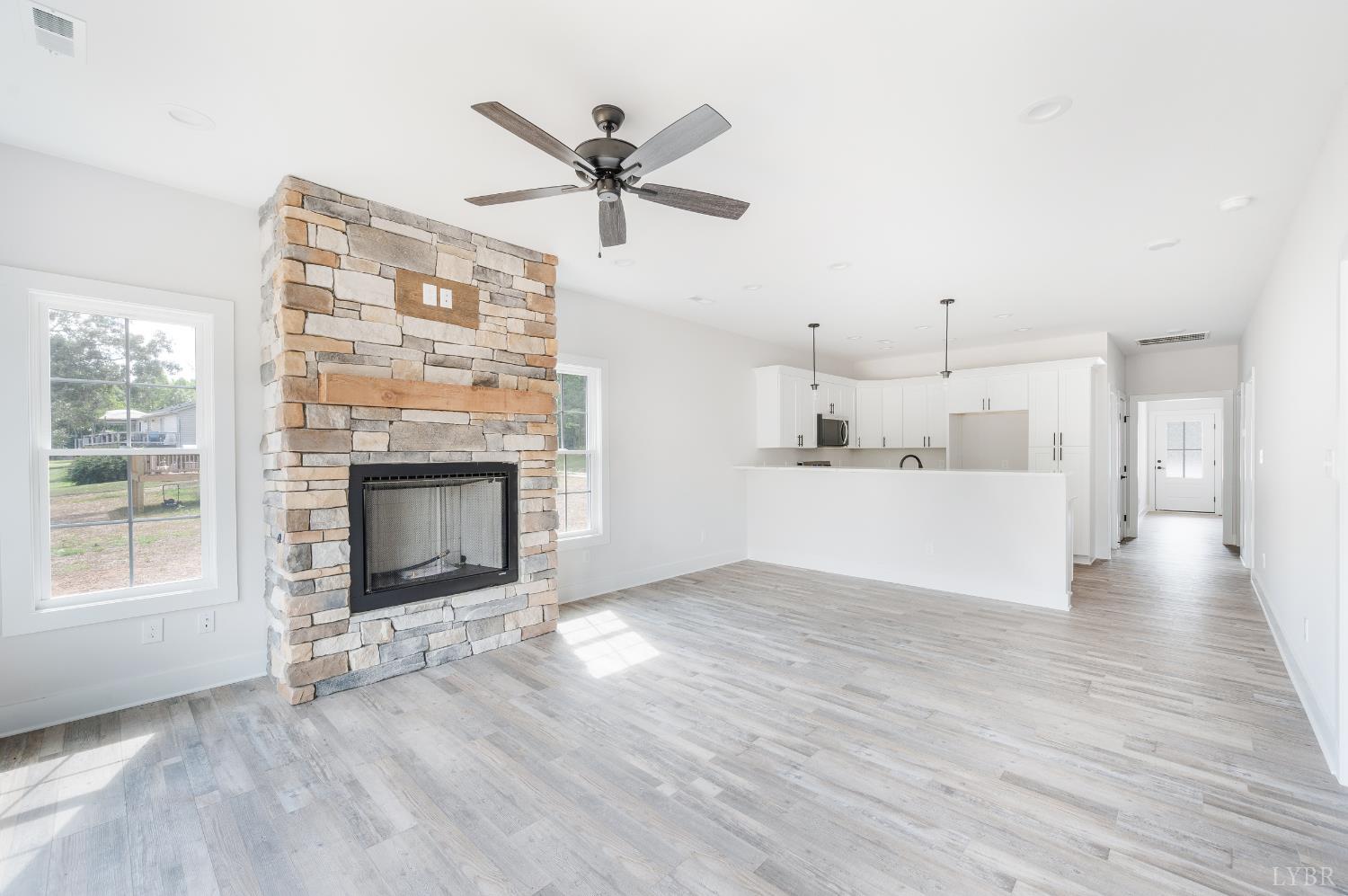 451 Dearborn Road Evington, VA 24550 - Photo 19 of 45 a view of a livingroom with a fireplace a ceiling fan and wooden floor