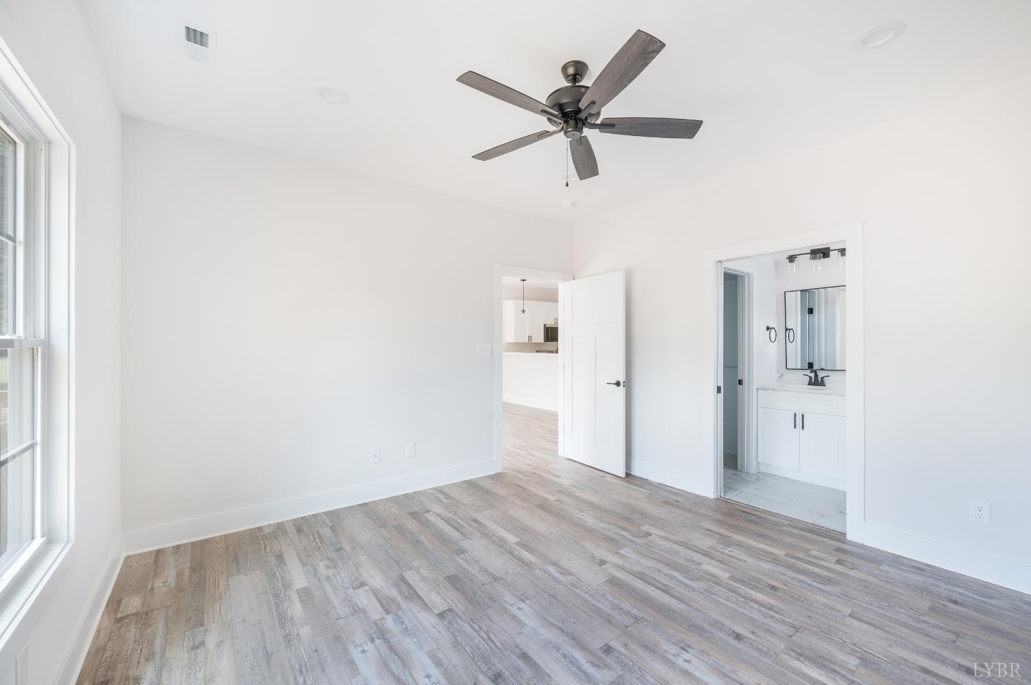 451 Dearborn Road Evington, VA 24550 - Photo 22 of 45 a view of a livingroom with wooden floor and a ceiling fan