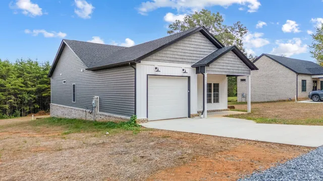 a view of a house with a yard and garage