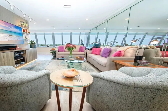 a living room with furniture and a potted plant