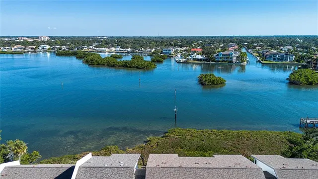 a view of a lake with couches in the backyard