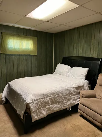 a bedroom with a bed and a couch