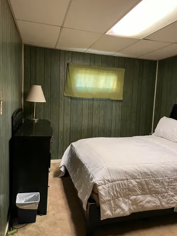 a bedroom with a bed and a lamp