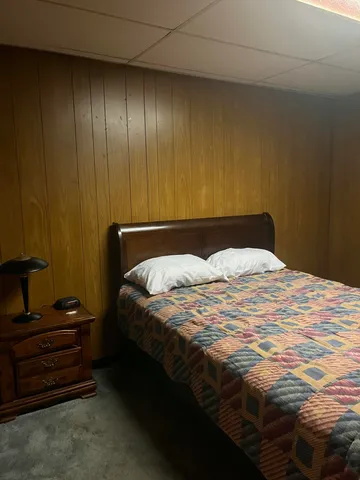 a bedroom with a bed and cabinets
