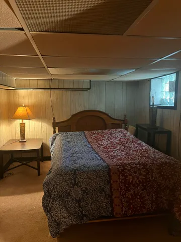 a bedroom with a bed and a table in it