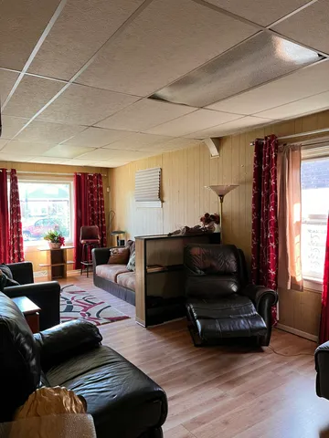 a living room with furniture window and wooden floor