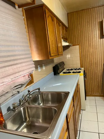 a kitchen with a sink and a stove top oven