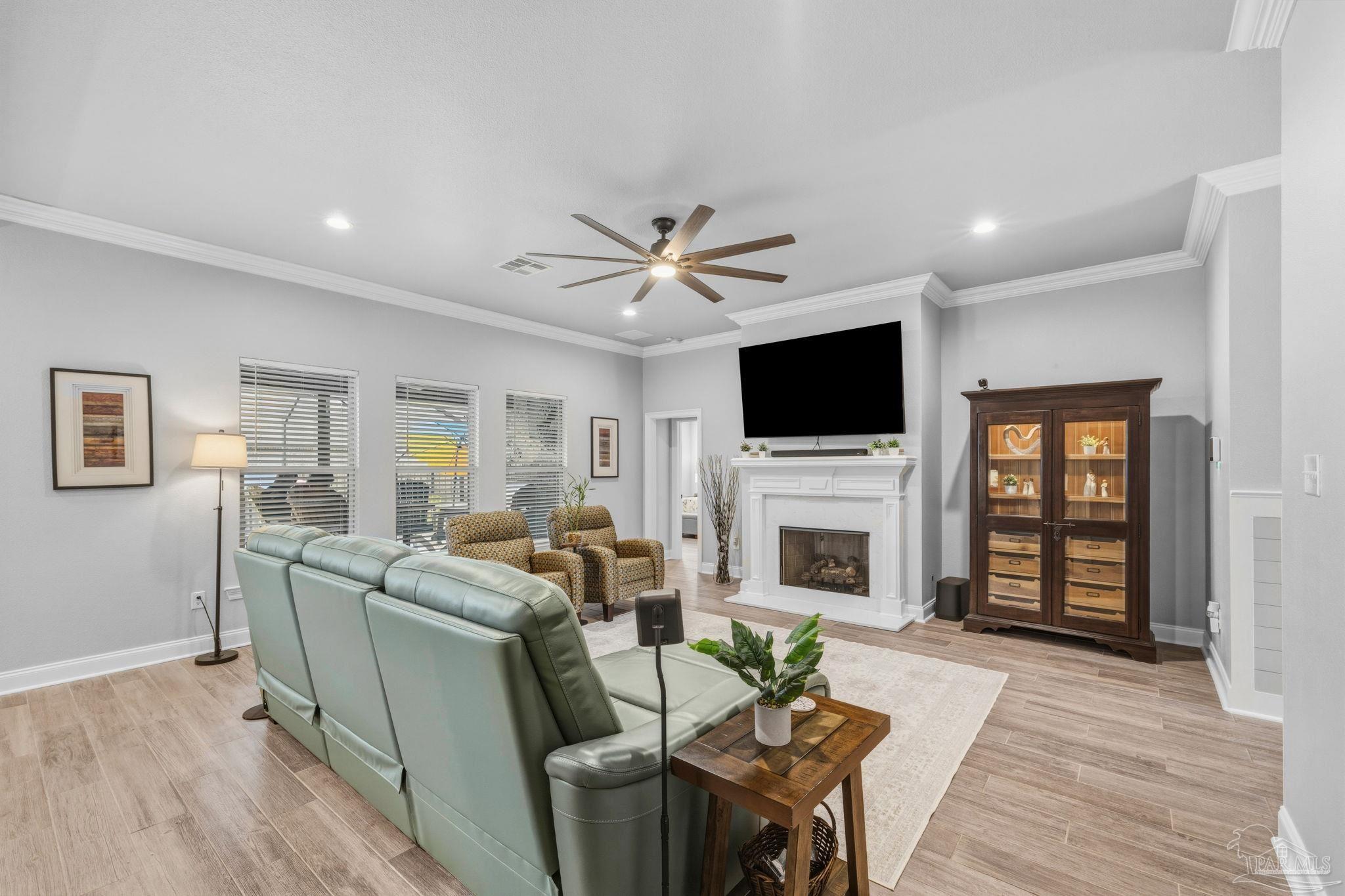 2129 Eagles Rdg Cove Cantonment, FL 32533 - Photo 11 of 66 a living room with furniture a fireplace and a flat screen tv