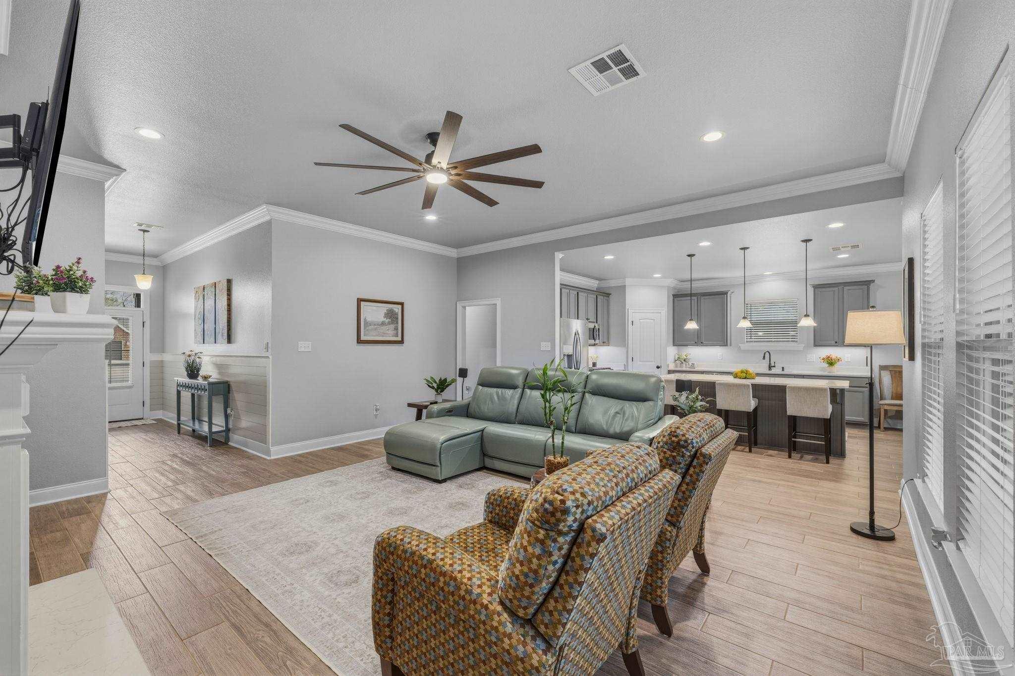 2129 Eagles Rdg Cove Cantonment, FL 32533 - Photo 12 of 66 a living room with furniture kitchen view and a chandelier