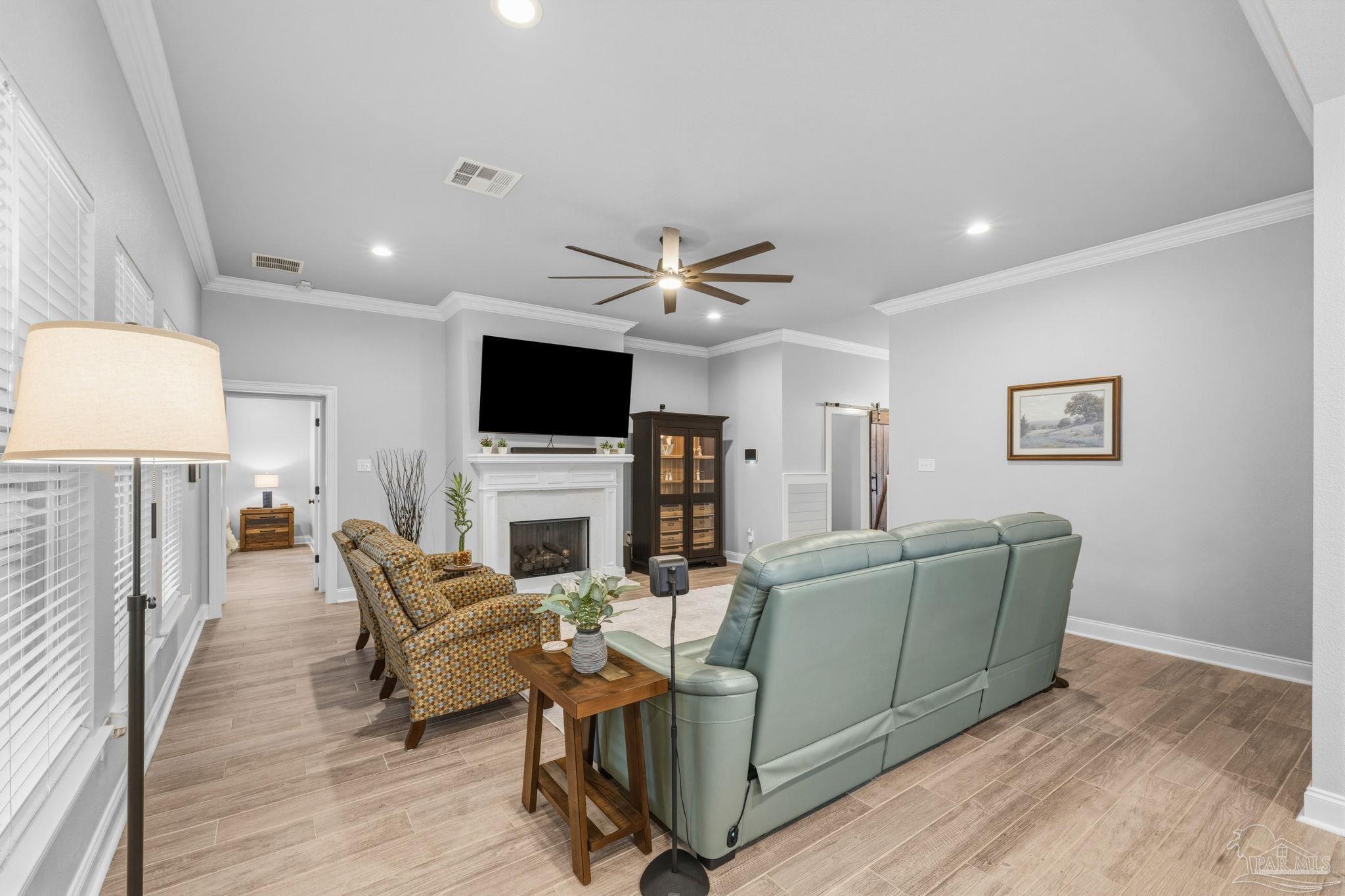 2129 Eagles Rdg Cove Cantonment, FL 32533 - Photo 13 of 66 a living room with furniture and a fireplace