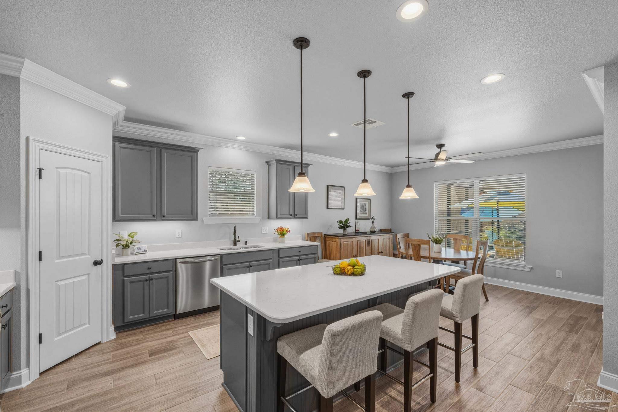 2129 Eagles Rdg Cove Cantonment, FL 32533 - Photo 18 of 66 a kitchen with a table chairs and wooden floor
