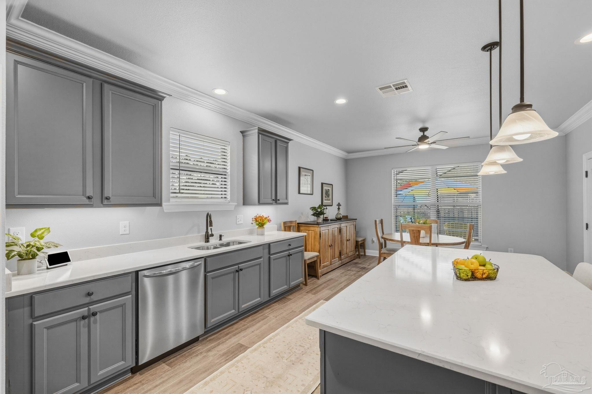 2129 Eagles Rdg Cove Cantonment, FL 32533 - Photo 20 of 66 a kitchen with a sink a counter appliances and cabinets