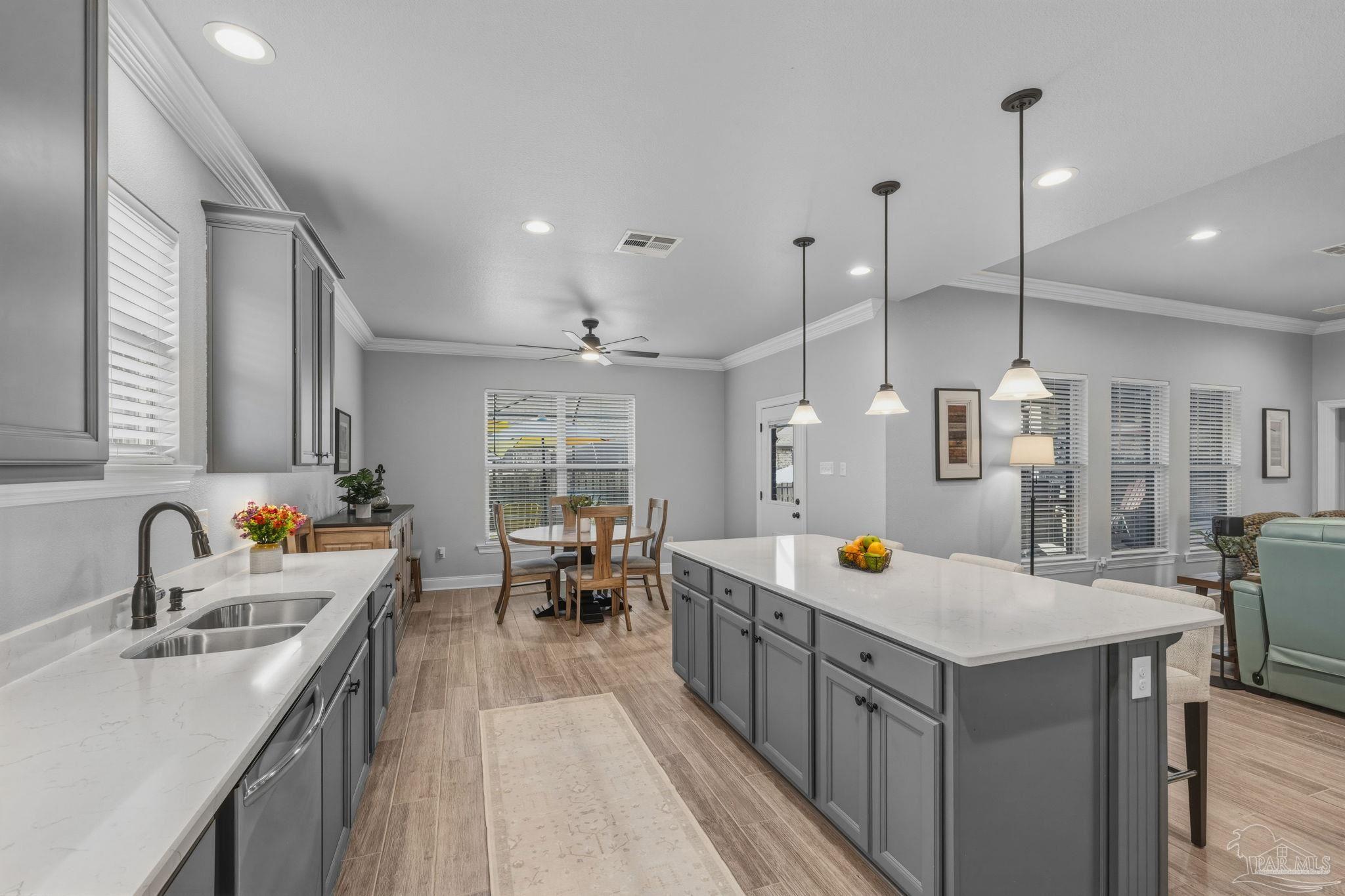 2129 Eagles Rdg Cove Cantonment, FL 32533 - Photo 22 of 66 a kitchen with sink stove and chairs