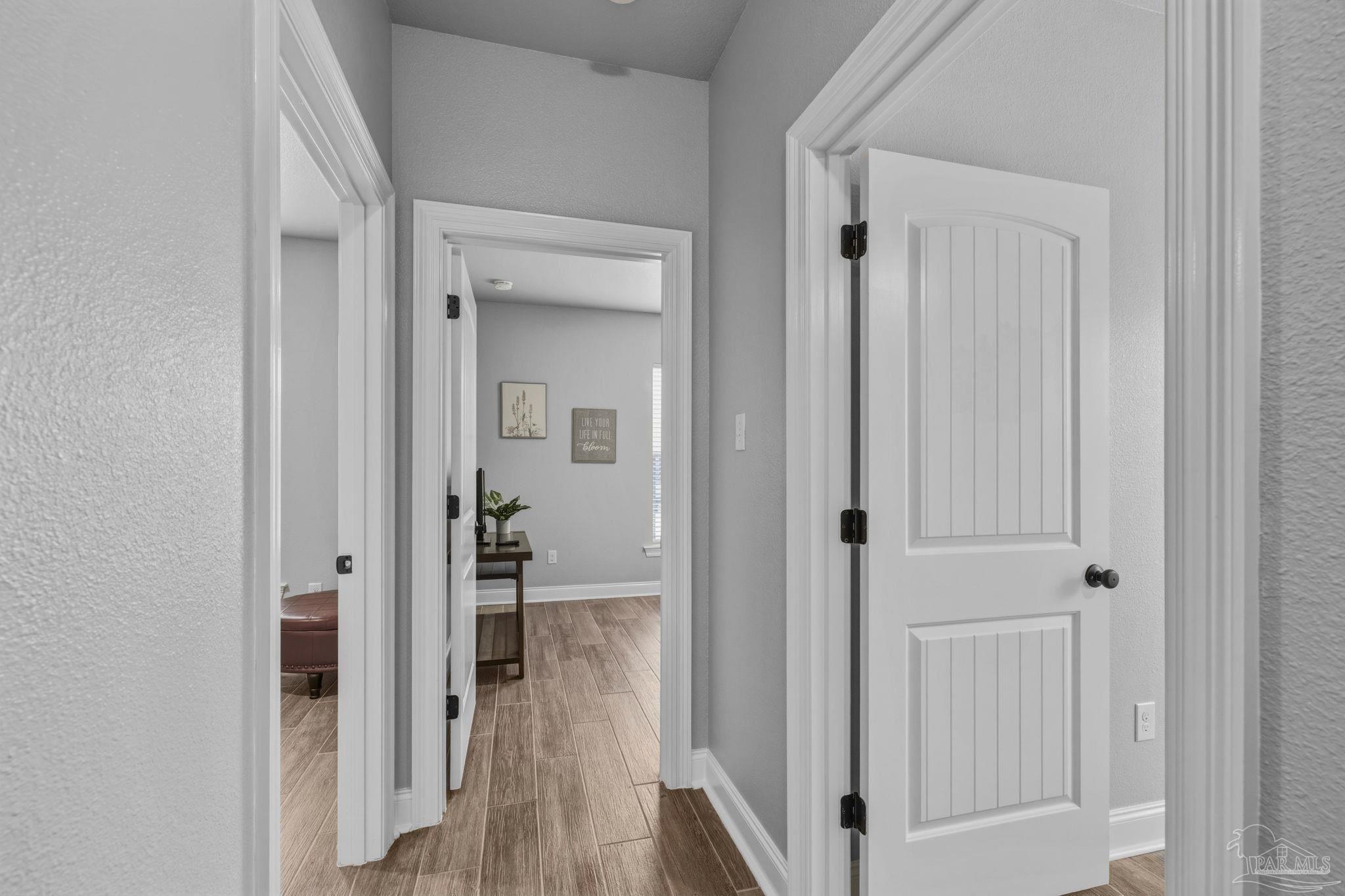 2129 Eagles Rdg Cove Cantonment, FL 32533 - Photo 28 of 66 a view of a hallway with wooden floor and closet