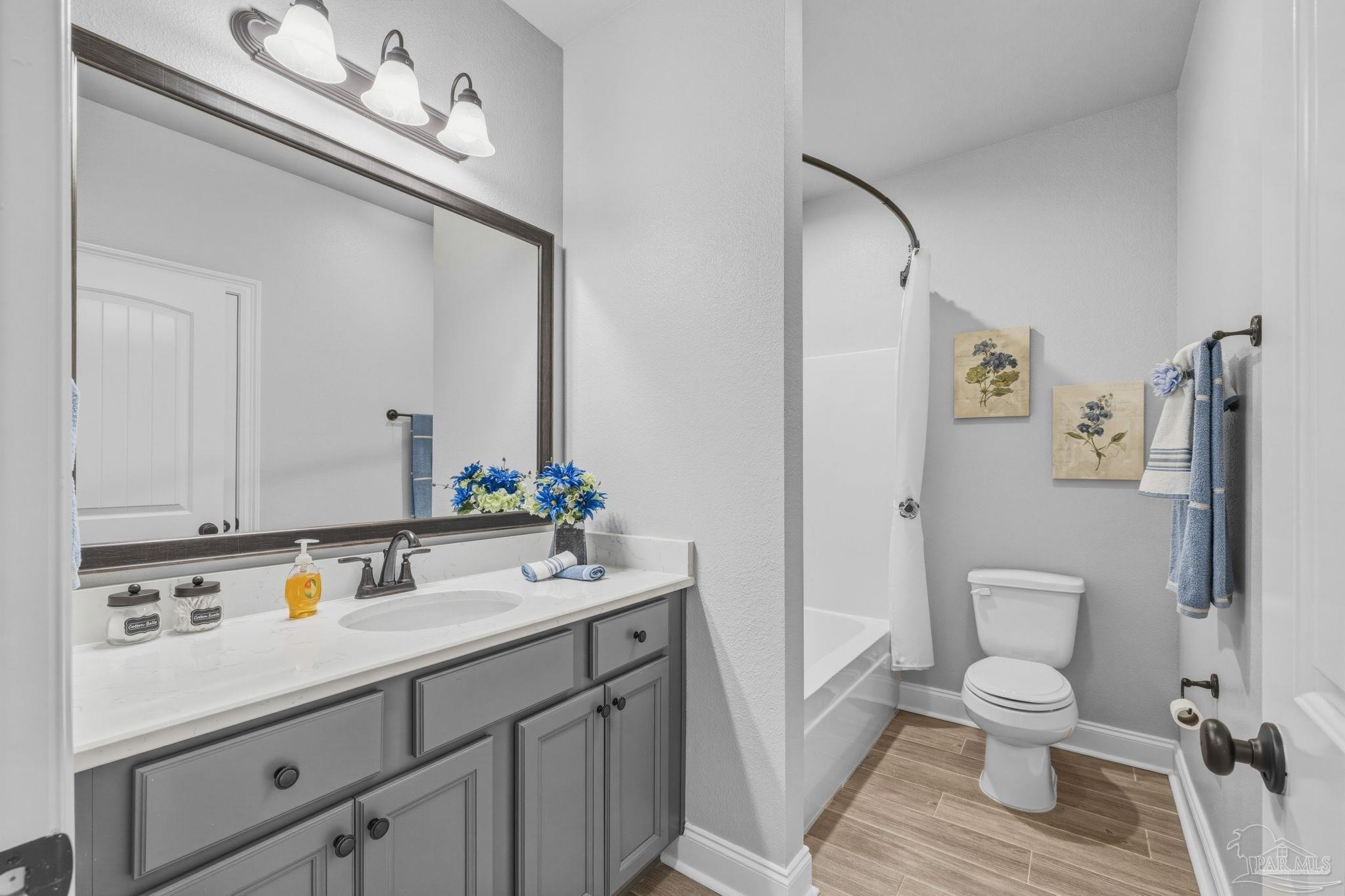 2129 Eagles Rdg Cove Cantonment, FL 32533 - Photo 29 of 66 a bathroom with a toilet a sink and mirror