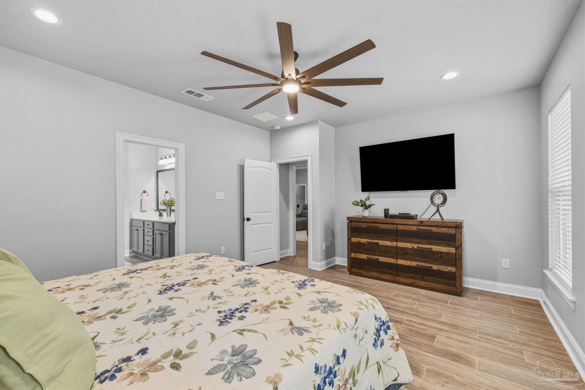 2129 Eagles Rdg Cove Cantonment, FL 32533 - Photo 37 of 66 a bedroom with a bed and a flat screen tv