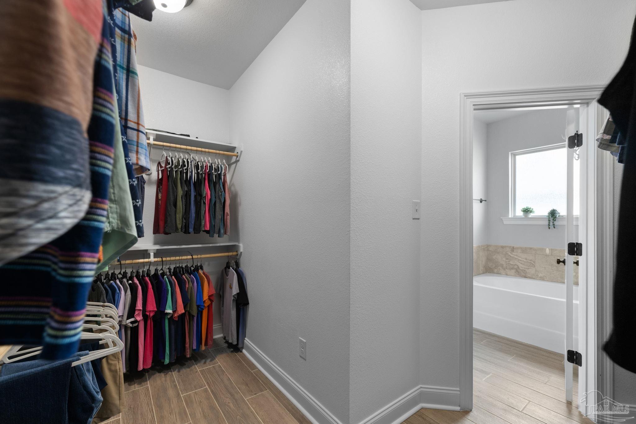 2129 Eagles Rdg Cove Cantonment, FL 32533 - Photo 42 of 66 a view of walk in closet with clothes and shoes