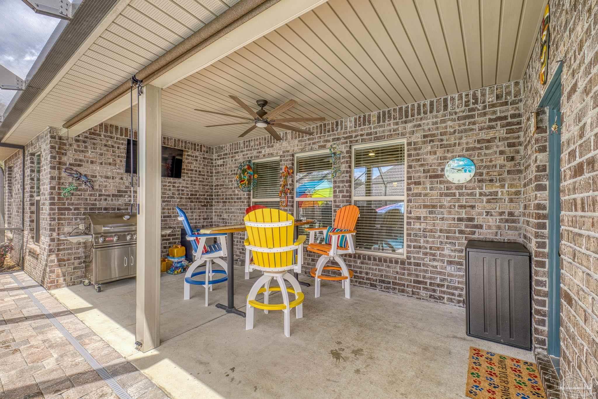 2129 Eagles Rdg Cove Cantonment, FL 32533 - Photo 43 of 66 a view of a patio with table and chairs and wooden floor