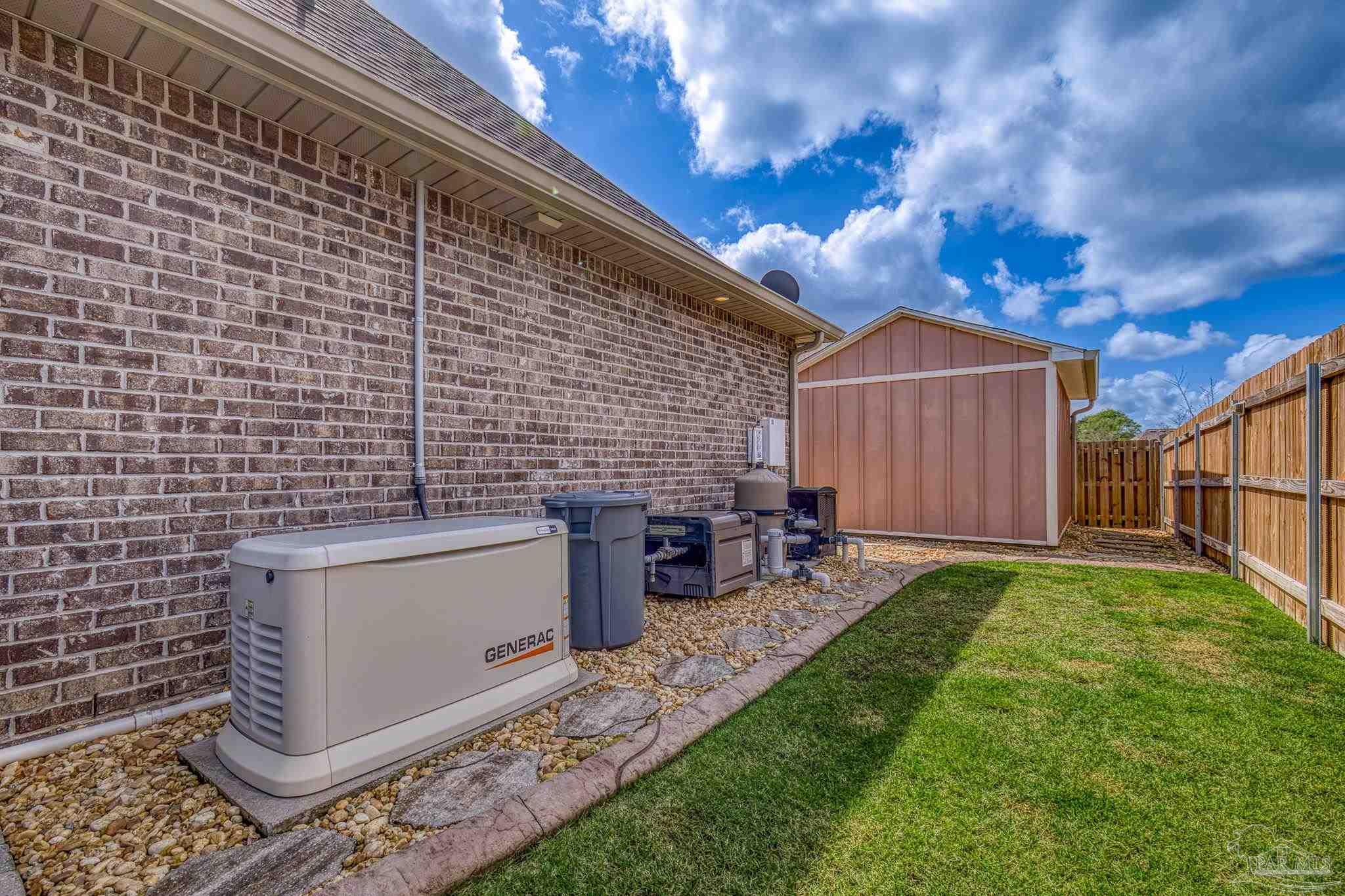 2129 Eagles Rdg Cove Cantonment, FL 32533 - Photo 59 of 66 a backyard of a house with table and chairs