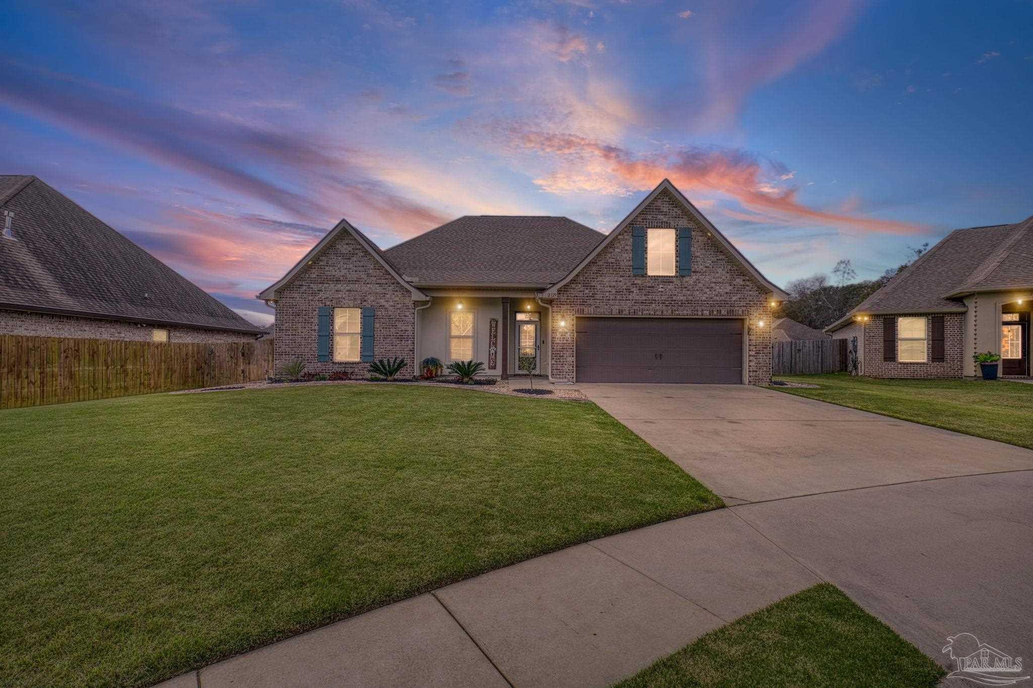 2129 Eagles Rdg Cove Cantonment, FL 32533 - Photo 61 of 66 a front view of a house with a garden