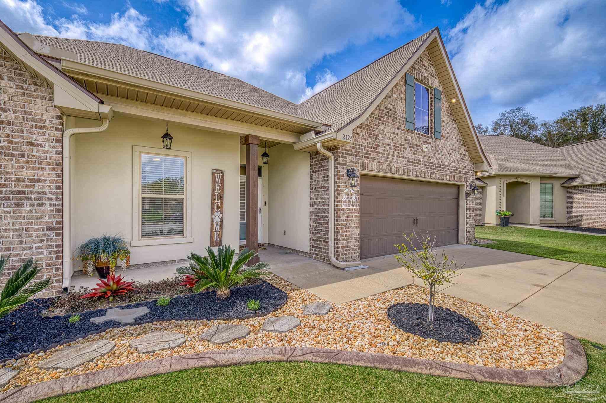 2129 Eagles Rdg Cove Cantonment, FL 32533 - Photo 65 of 66 a front view of a house with garden
